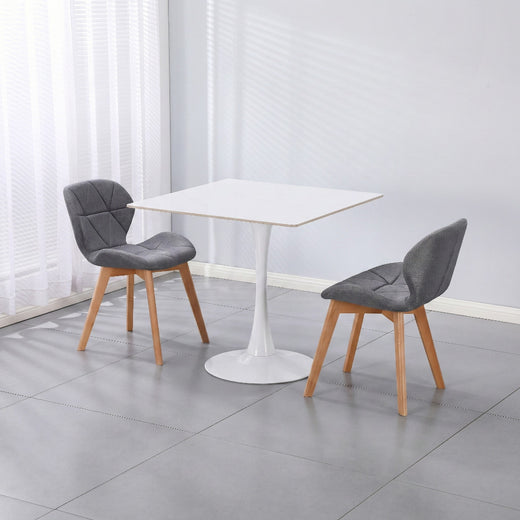 Two gray fabric chairs on a white ceramic coated table on a lifestyle background
