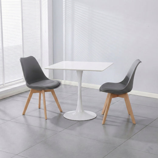 Two black PU leather chairs and a white ceramic coated table on a lifestyle background