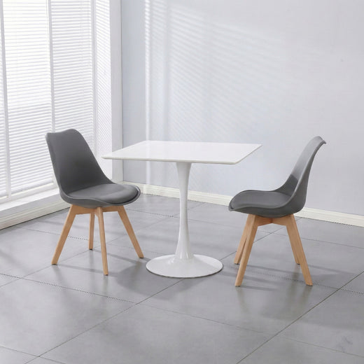 Two grey PU leather chairs and a white ceramic coated table on a lifestyle background