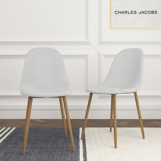 Two white velvet chairs on a white background