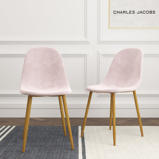 Two pink velvet chairs on a lifestyle background
