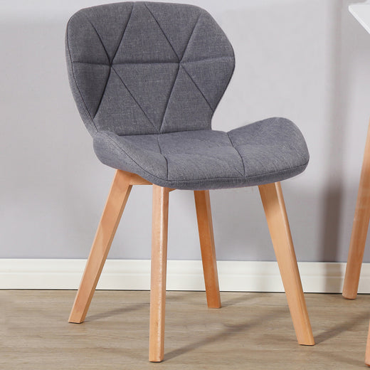 A dark grey fabric chair on a lifestyle background